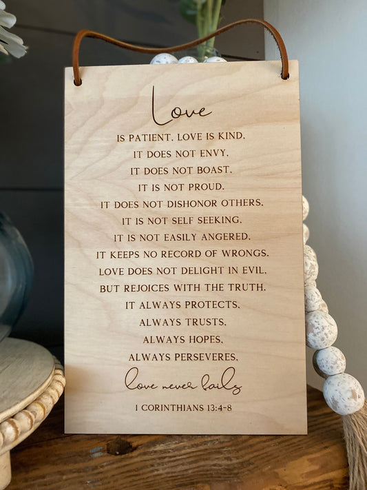 Love Never Fails Wood Wall Hanging